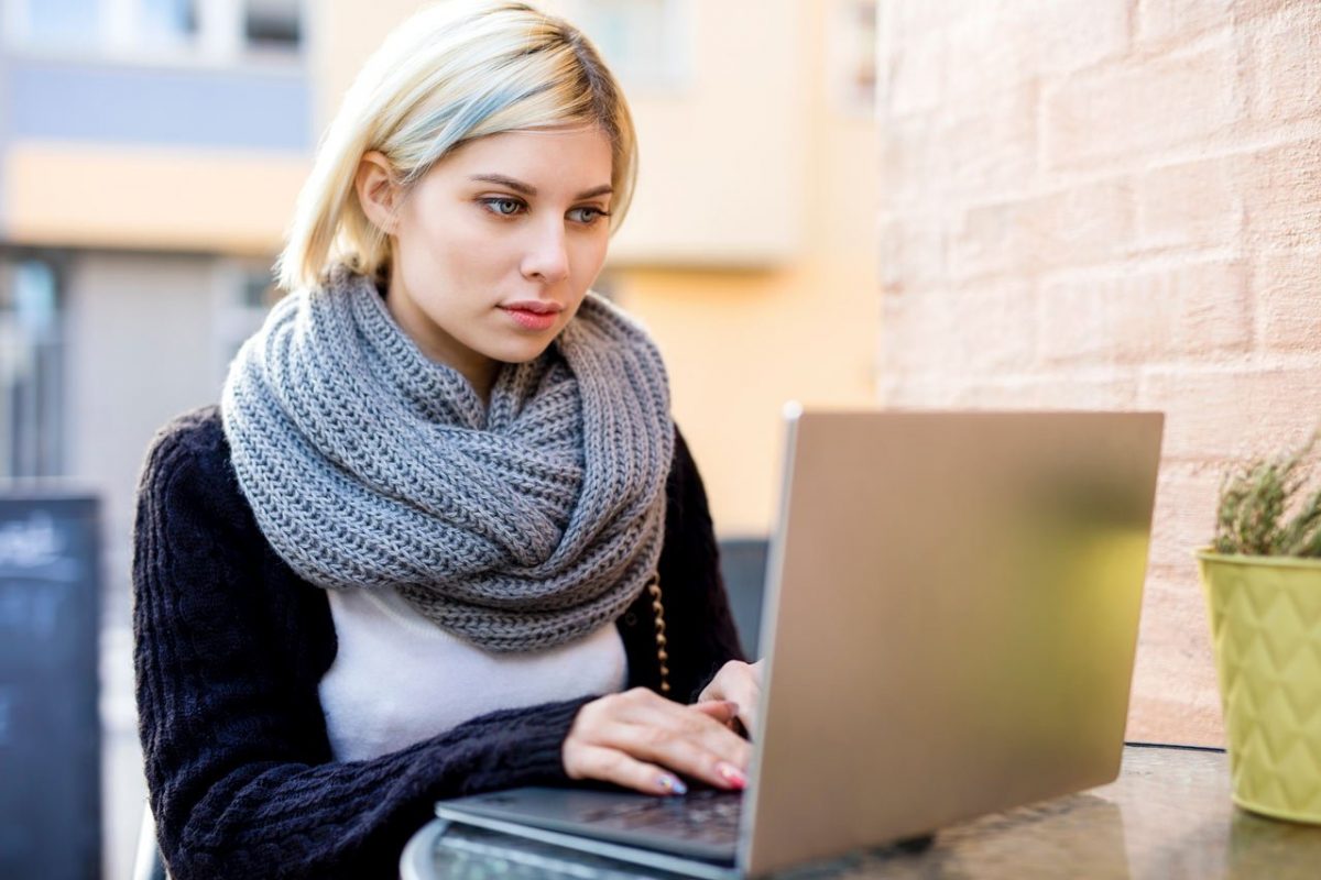 3-Ways-to-Boost-Blog-Traffic-Featured-Image-young-focused-woman-working-on-laptop-at-outdoor